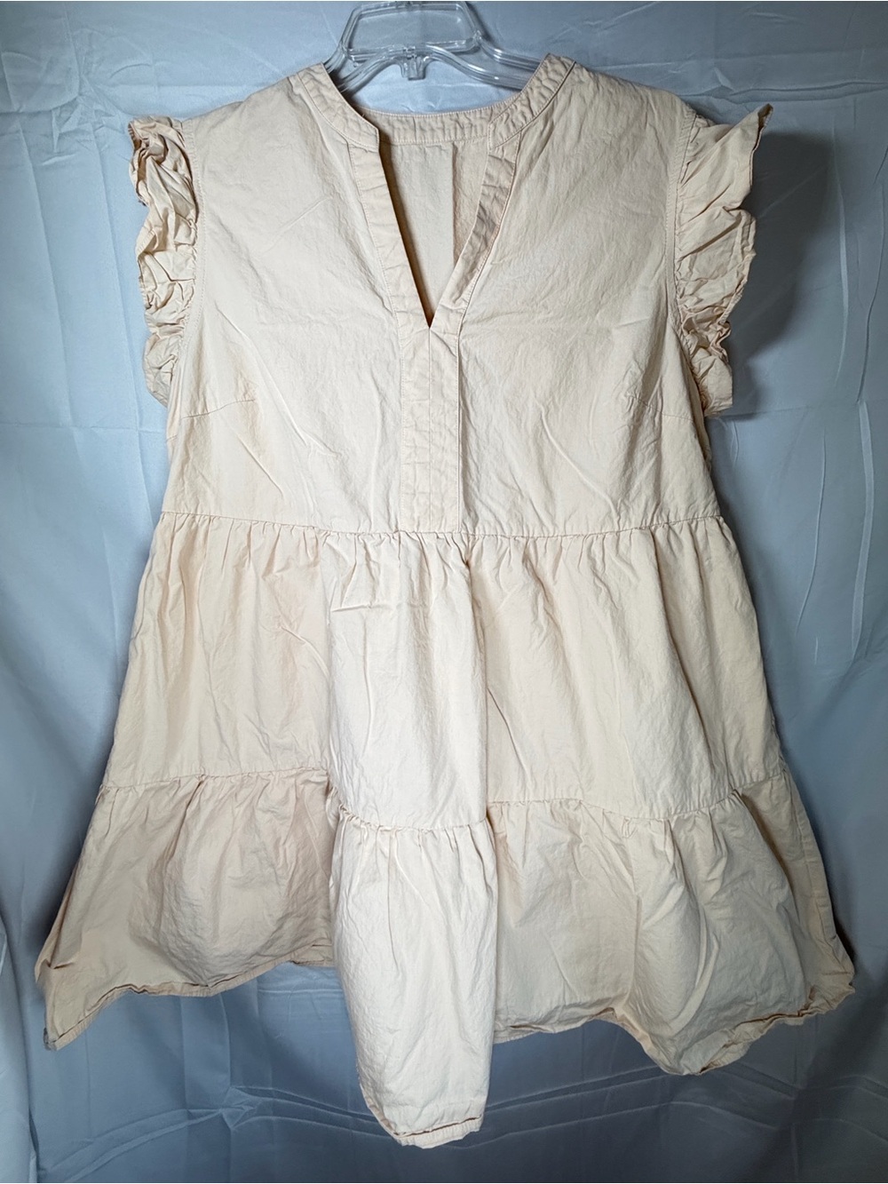 Light babydoll swing mini dress features a V-neckline
